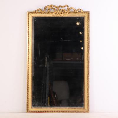 A large French Neoclassical Revival giltwood mirror with ribbon crest C 1890 