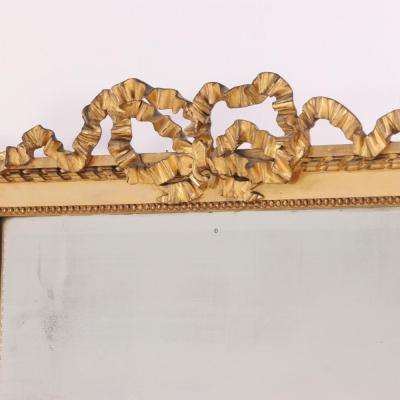 A large French Neoclassical Revival giltwood mirror with ribbon crest C 1890 