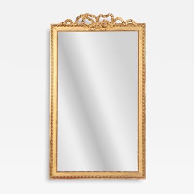 A large French Neoclassical Revival giltwood mirror with ribbon crest C 1890 