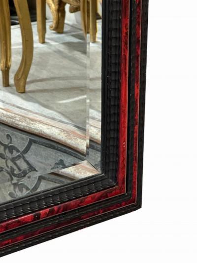 A large French ripple carved and faux tortoiseshell cushion mirror 