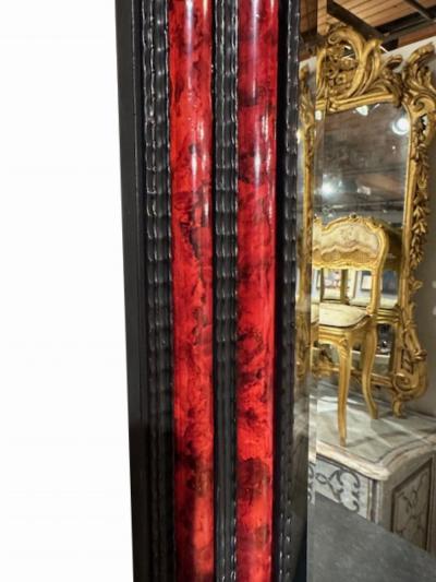 A large French ripple carved and faux tortoiseshell cushion mirror 