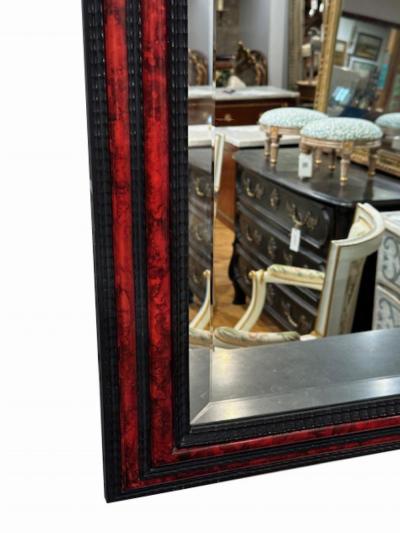 A large French ripple carved and faux tortoiseshell cushion mirror 