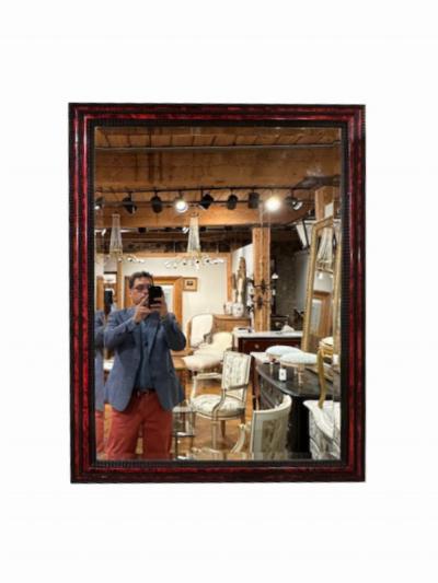 A large French ripple carved and faux tortoiseshell cushion mirror 