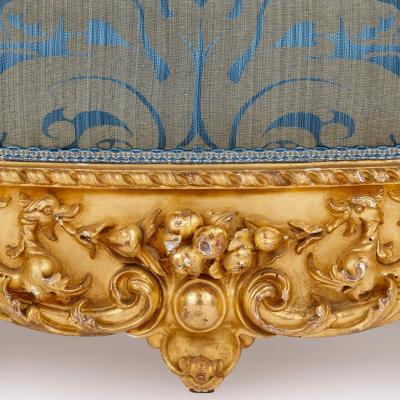 A large Rococo revival carved giltwood sofa