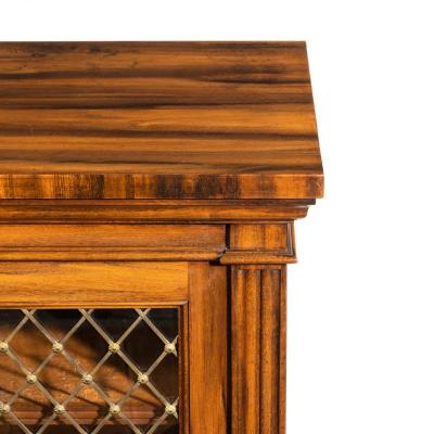 A late Regency Gon alo Alves two door side cabinet attributed to Gillows