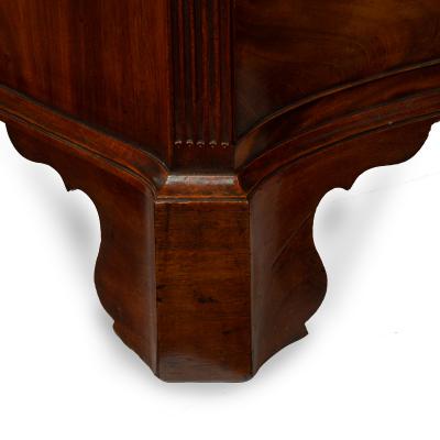 A mahogany four drawer serpentine chest of drawers