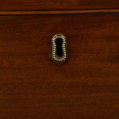 A mahogany four drawer serpentine chest of drawers
