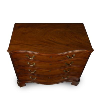 A mahogany four drawer serpentine chest of drawers