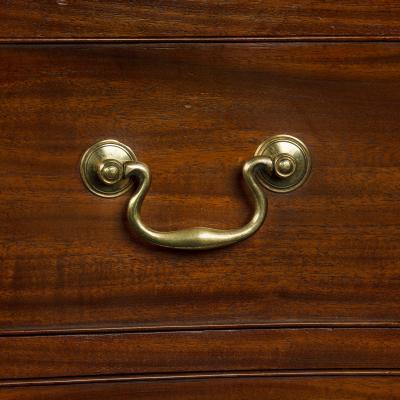 A mahogany four drawer serpentine chest of drawers