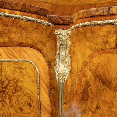 A mid Victorian kingwood serpentine cabinet