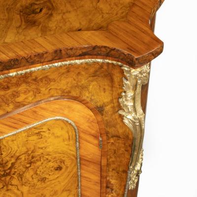 A mid Victorian kingwood serpentine cabinet