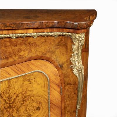 A mid Victorian kingwood serpentine cabinet