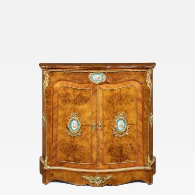 A mid Victorian kingwood serpentine cabinet