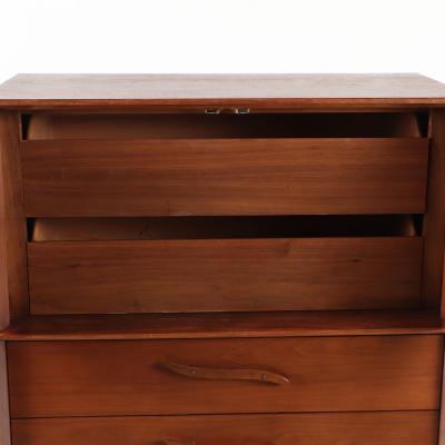 A mid century modern walnut highboy cabinet circa 1960 