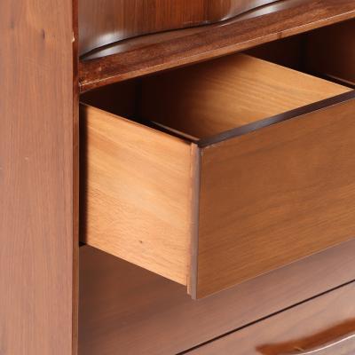A mid century modern walnut highboy cabinet circa 1960 