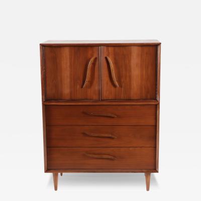 A mid century modern walnut highboy cabinet circa 1960 