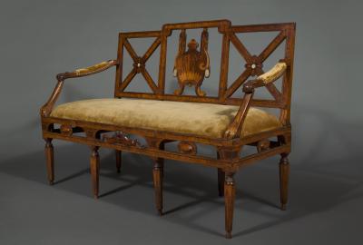 A most unusual set of four neoclassical marquetry inlaid chairs and a settee