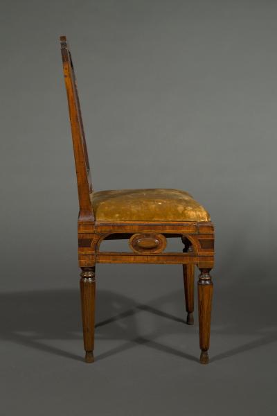 A most unusual set of four neoclassical marquetry inlaid chairs and a settee