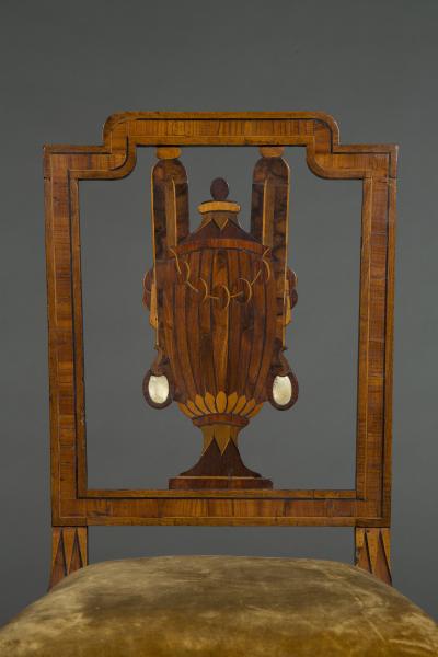 A most unusual set of four neoclassical marquetry inlaid chairs and a settee