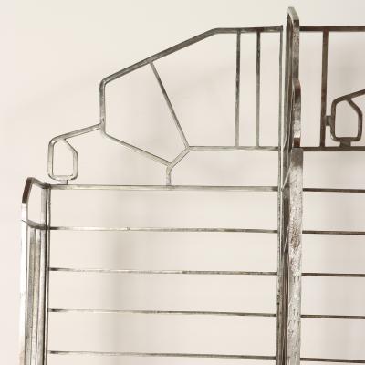 A nickel over iron Art Deco bakers rack with glass shelves French C 1930 