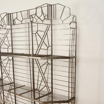 A nickel over iron Art Deco bakers rack with glass shelves French C 1930 