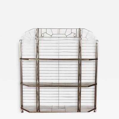 A nickel over iron Art Deco bakers rack with glass shelves French C 1930 