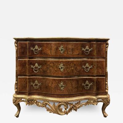 A northern European walnut burl carved and gilded three drawers commode 