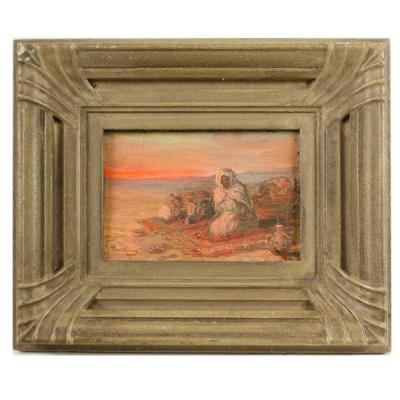 A oil on board painting of Bedouin men on beach in sunset signed indistinctly 
