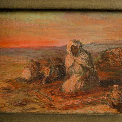 A oil on board painting of Bedouin men on beach in sunset signed indistinctly 