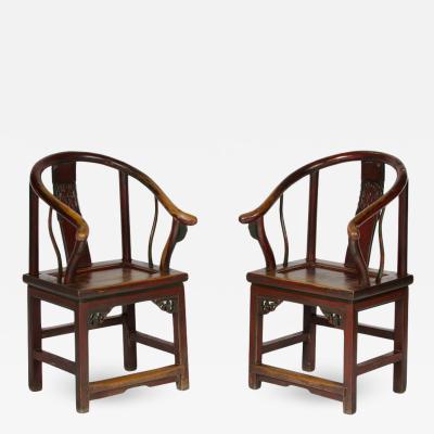 A pair of 19th Century Chinese painted horseshoe back armchairs