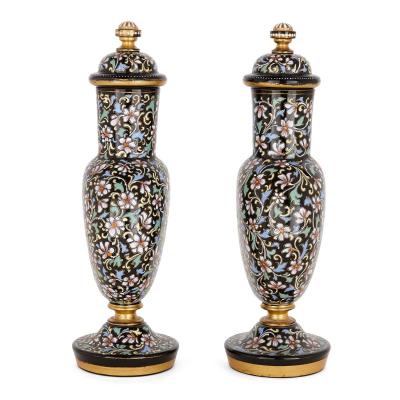A pair of Bohemian enamelled black glass vases and covers