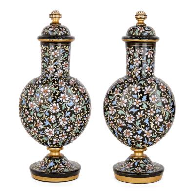 A pair of Bohemian enamelled black glass vases and covers