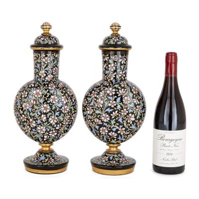 A pair of Bohemian enamelled black glass vases and covers