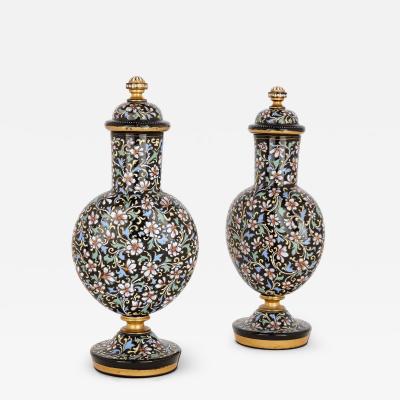 A pair of Bohemian enamelled black glass vases and covers