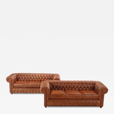 A pair of Chesterfield style leather sofas 