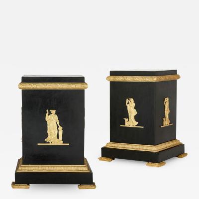 A pair of Empire style Neoclassical gilt and patinated bronze stands