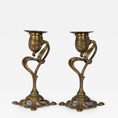 A pair of English Art Nouveau candlesticks with flowing organic decor