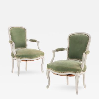 A pair of French Louis XV painted open armchairs 18th C 