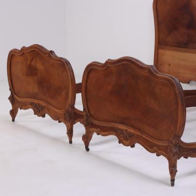 A pair of French Louis XV style walnut twin beds C 1900 