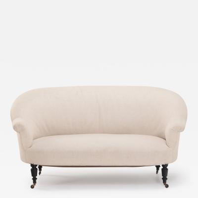 A pair of French Napoleon III sofas with continuous backs circa 1860 
