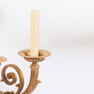 A pair of French Neoclassical style gilt bronze sconces having classical masks 