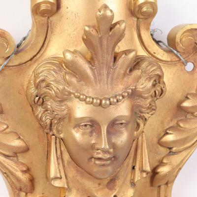 A pair of French Neoclassical style gilt bronze sconces having classical masks 