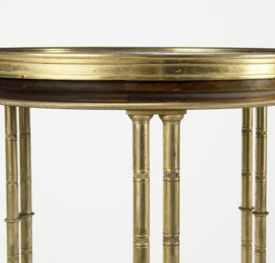 A pair of Louis XVI style mahogany and ormolu gueridons after Adam Weisweiler