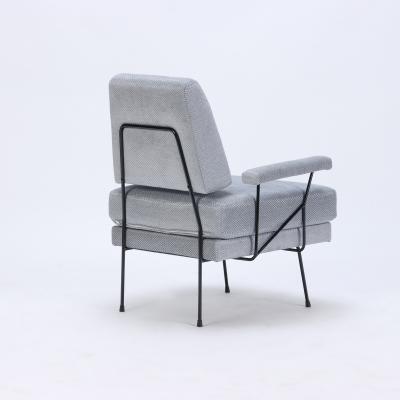 A pair of Mid Century Modern iron armchairs newly upholstered 