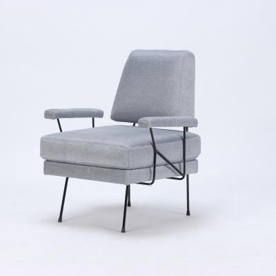 A pair of Mid Century Modern iron armchairs newly upholstered 