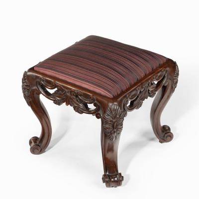 A pair of Victorian carved mahogany stools