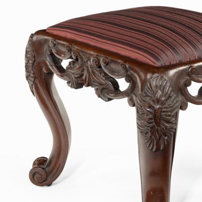 A pair of Victorian carved mahogany stools