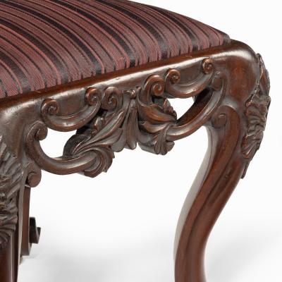 A pair of Victorian carved mahogany stools