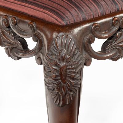 A pair of Victorian carved mahogany stools