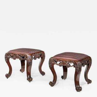 A pair of Victorian carved mahogany stools